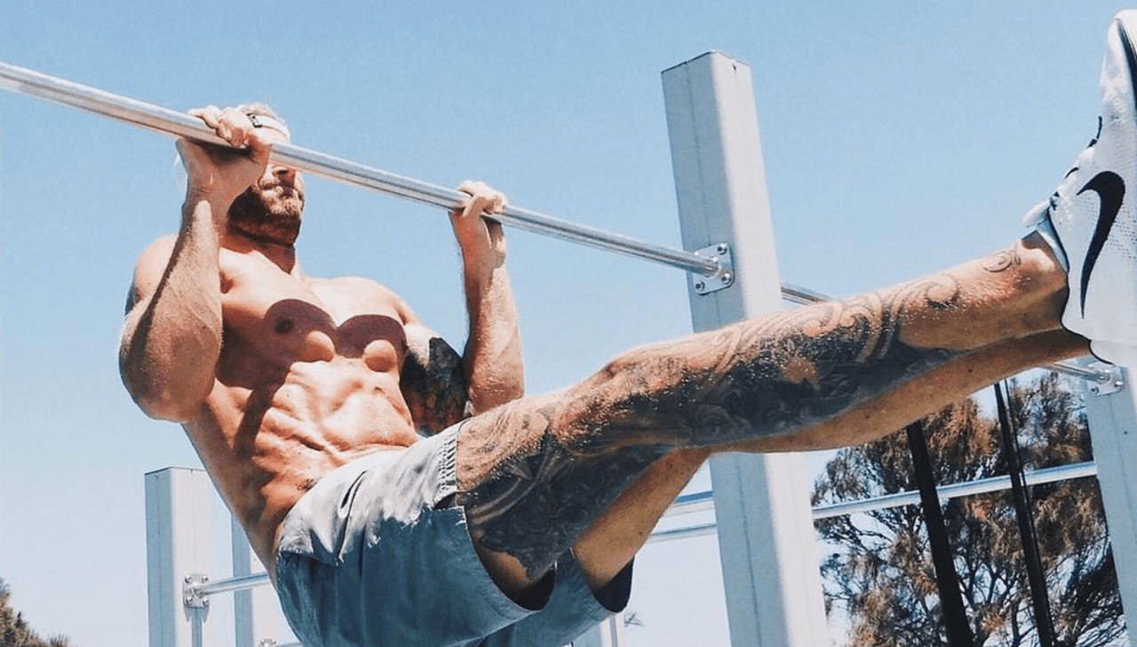 Man Doing pull ups on outdoor Calisthenics Gym