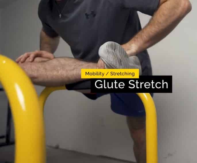 glute stretch on the dip bar